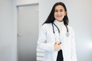 Portrait of happy female doctor with stethoscope in office
